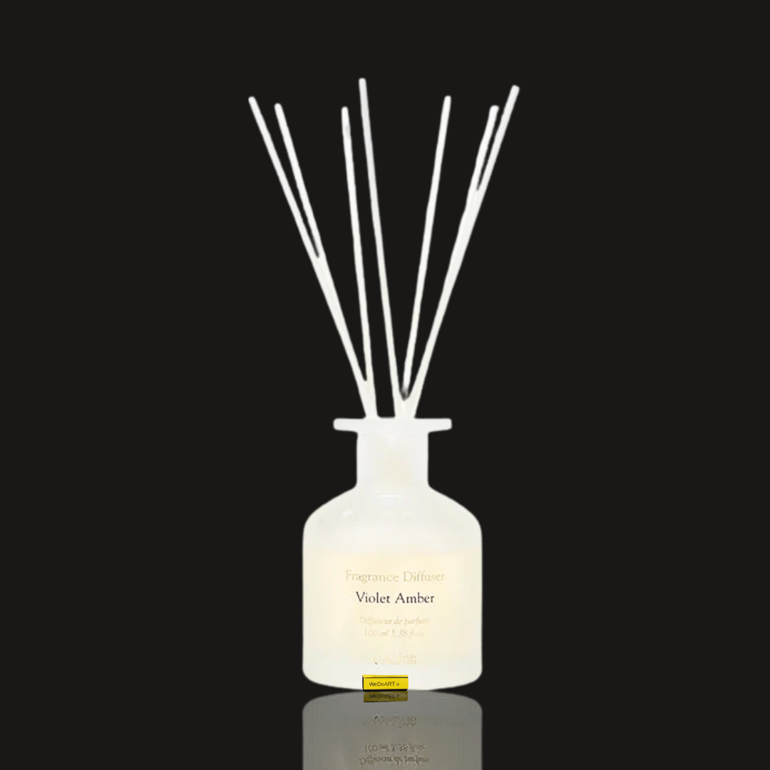Laline Violet Amber reed diffuser in a frosted white glass bottle with a bundle of white reeds