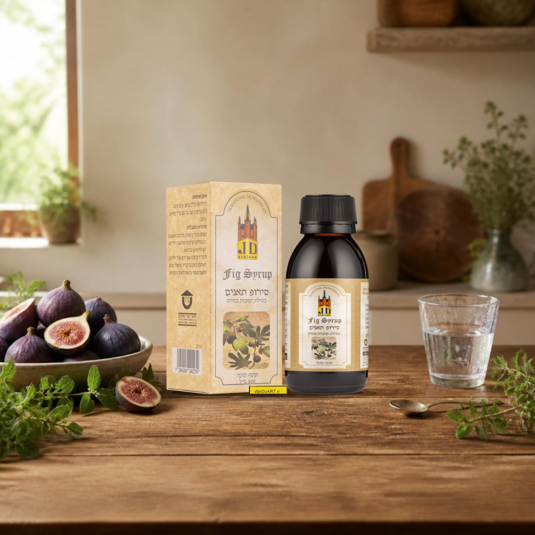 J.D. Schloss Fig Syrup 100 ml bottle and box on a wooden kitchen counter with fresh figs and a glass of water