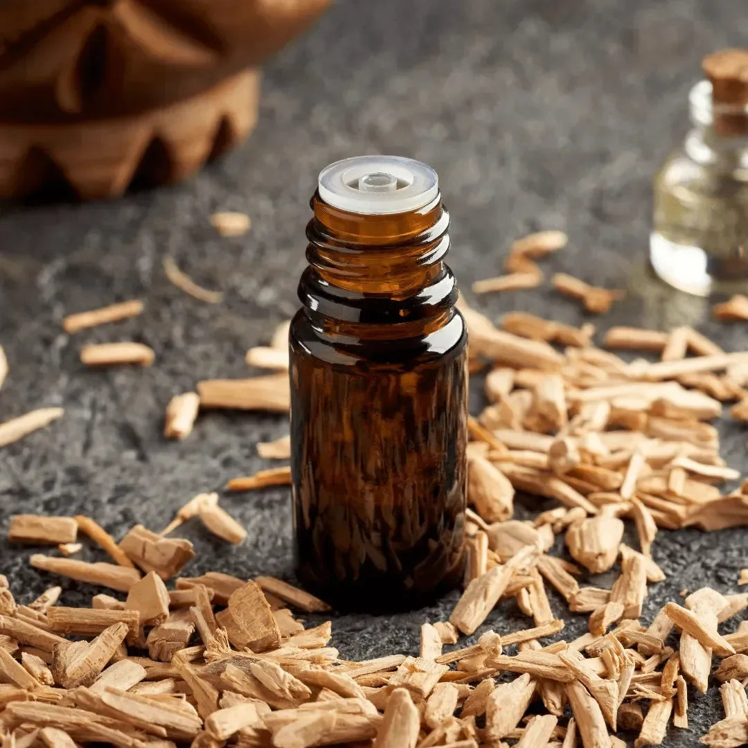 Dark bottle standing among light cedar wood shavings