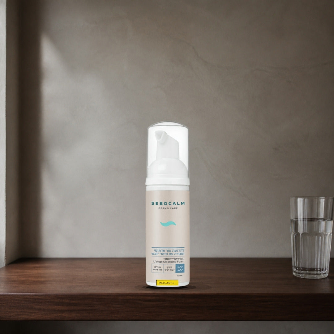 Sebocalm L'Atopi cleansing foam 150 ml on a dark walnut shelf beside a glass of water