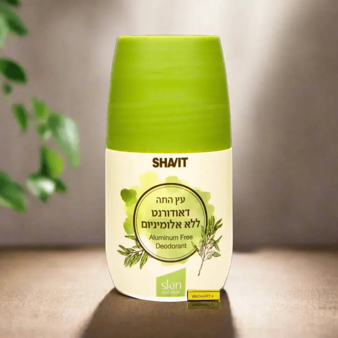 SHAVIT tea tree roll-on deodorant bottle with green cap beside green leaves