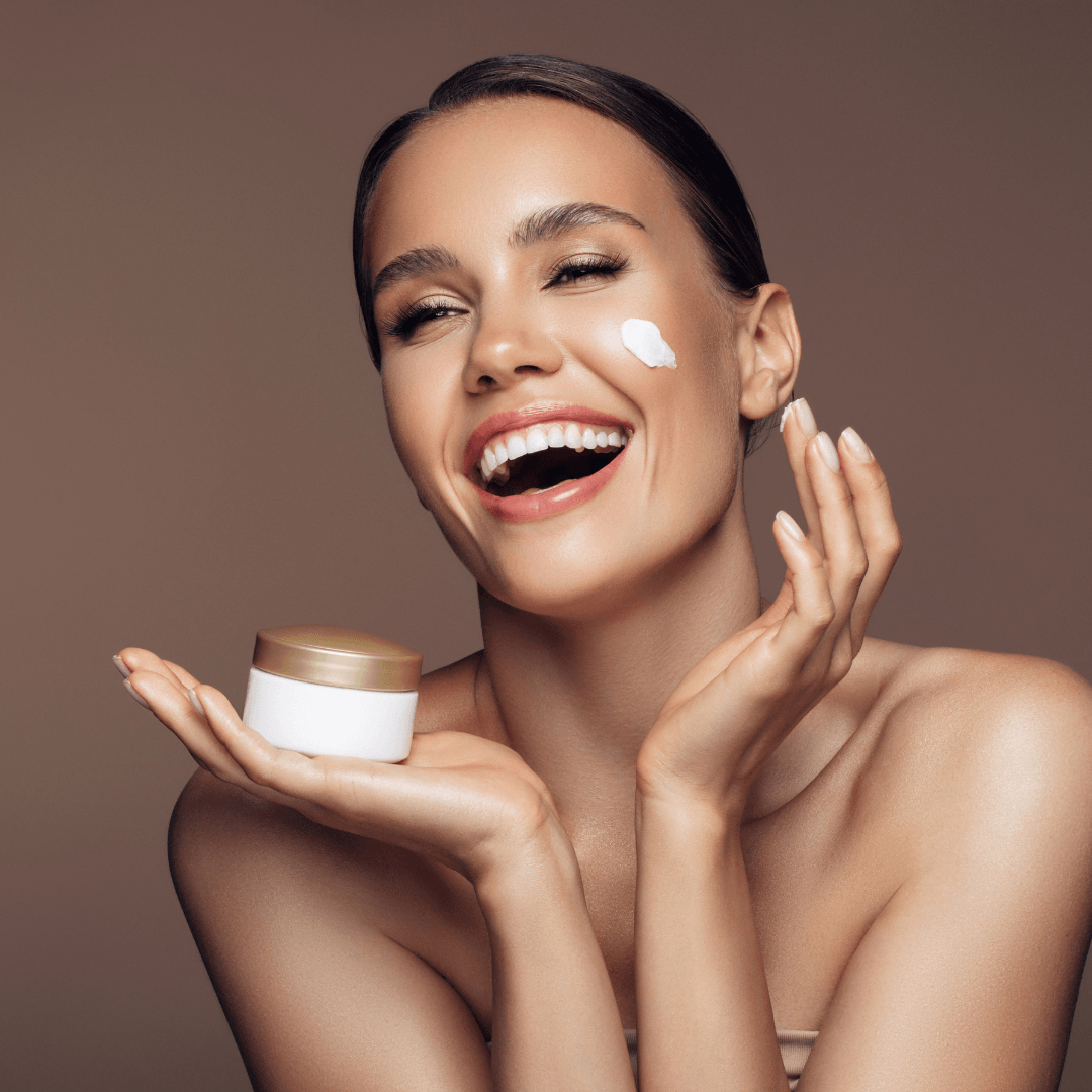 Smiling woman applying face cream with cosmetic jar, promoting skincare by WEDOART-IL