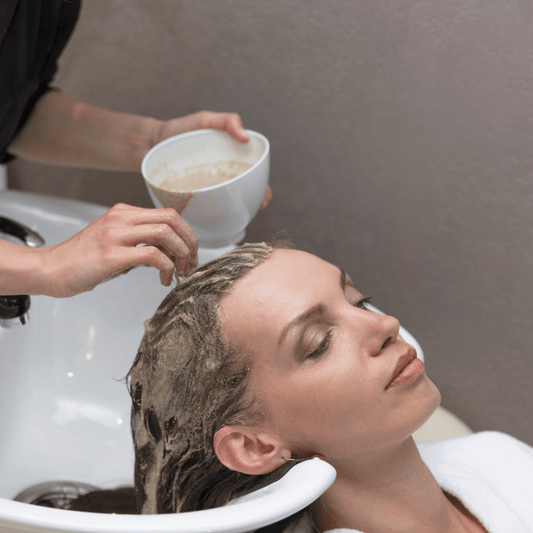 Woman receiving nourishing hair mask treatment at salon sink, WEDOART-IL hair care