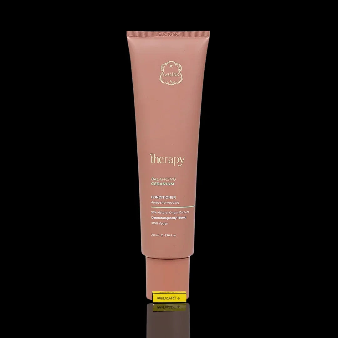 Therapy Balancing Geranium Conditioner tube in soft pink packaging against a black background.