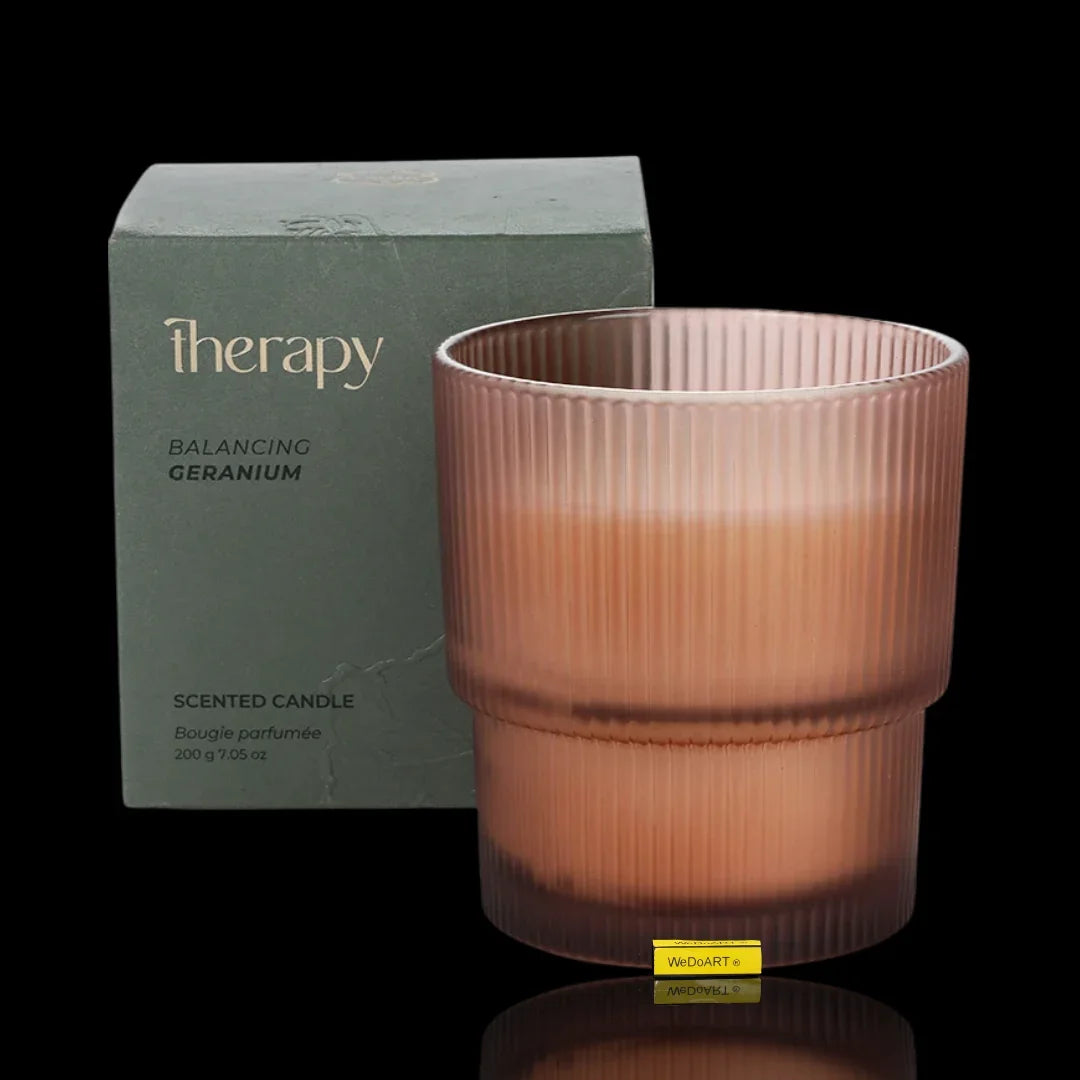 Therapy Balancing Geranium scented candle in a pink ribbed glass jar with packaging.