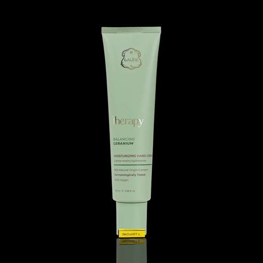 Therapy Balancing Geranium Moisturizing Hand Cream tube against a black background.