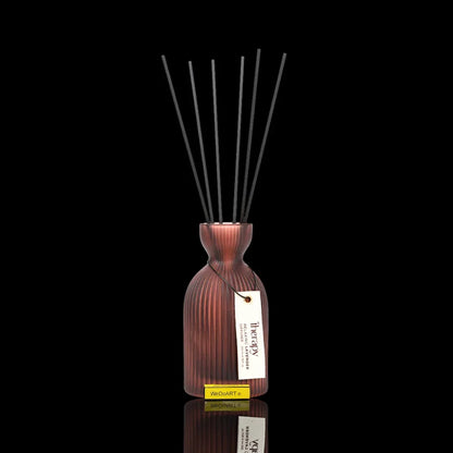 Therapy lavender reed diffuser in a ribbed terracotta vase against a black background