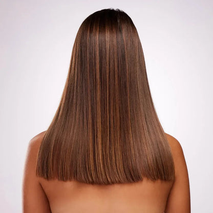 Back view of a woman with long, straight, glossy brown hair with caramel highlights