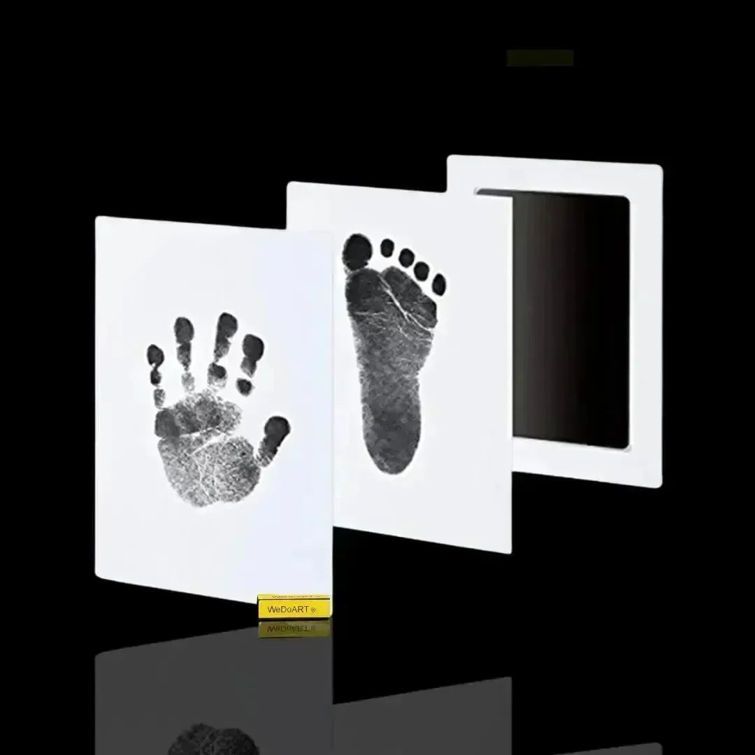 Elysium-Baby baby footprint kit with a black clean-touch ink pad and white cards showing a baby handprint and footprint