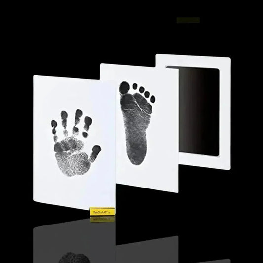 Elysium-Baby baby footprint kit with a black clean-touch ink pad and white cards showing a baby handprint and footprint