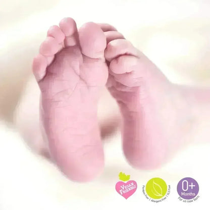 Baby's feet with vegan friendly, paraben free and 0+ months badges