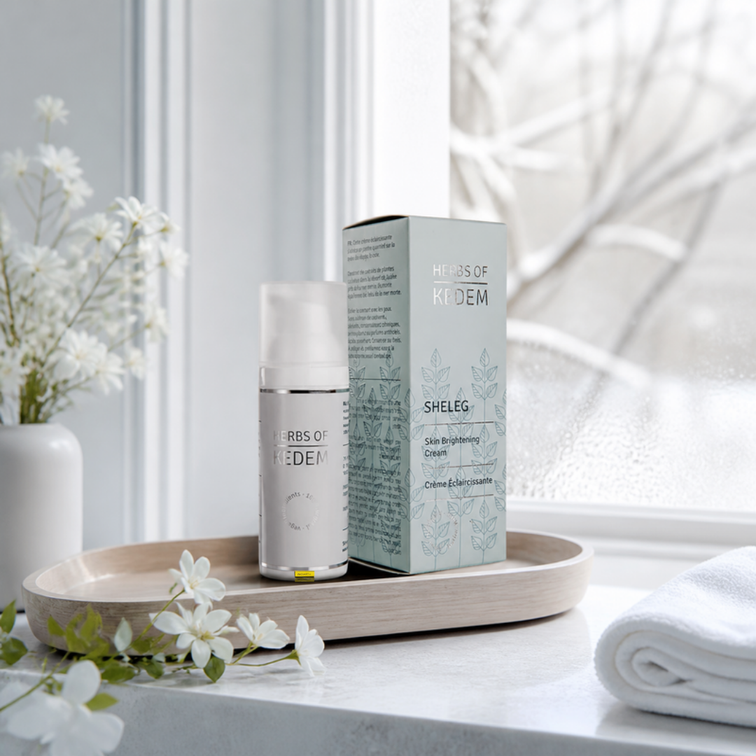 Herbs of Kedem Sheleg skin-brightening cream, 50 ml, on a birch tray by a frosted, snowy window