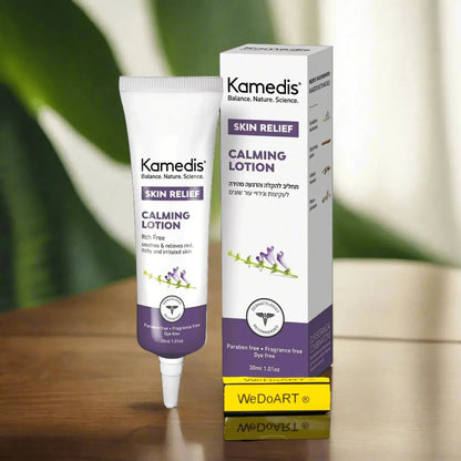 Kamedis Calming Lotion tube and carton on a wooden table with a green plant behind
