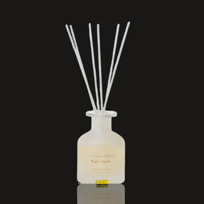 Laline Classic Warm Vanilla reed diffuser 100 ml, a frosted glass bottle with white reeds on a dark background