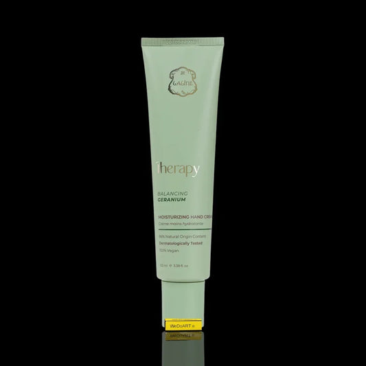 Therapy Balancing Geranium Moisturizing Hand Cream tube against a black background.