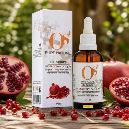 OS+ PURE NATURE organic pomegranate seed oil bottle and box with fresh pomegranates on a wooden table