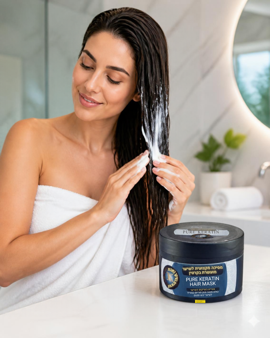 Woman applying PRO HAIR+ keratin hair mask to wet hair beside the jar on a marble bathroom counter
