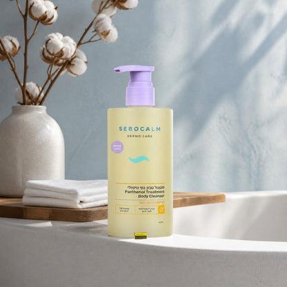 Sebocalm cotton body cleanser 460 ml on a white bathtub edge with dried cotton stems and a linen towel