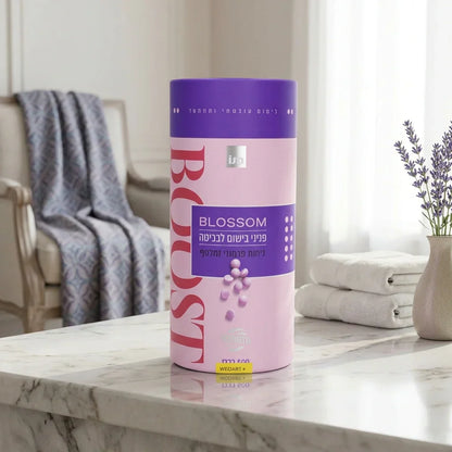 Blossom Boost skincare product on marble counter with lavender, towels, and cozy chair background
