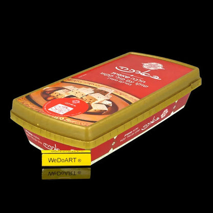 Red Baraka tray of chocolate halva with cocoa beans and a gold lid, seen from the side