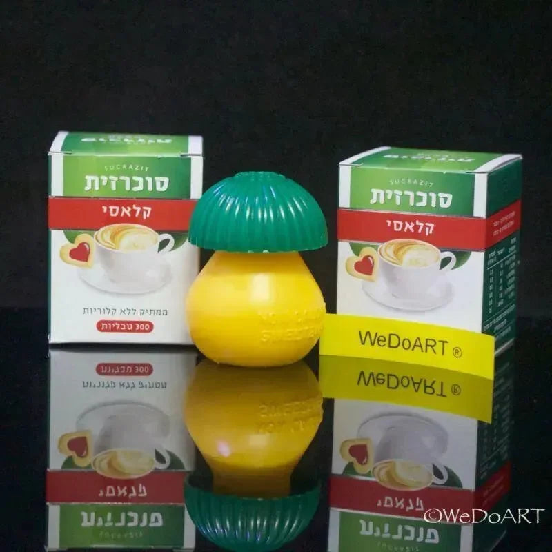 Sucrazit Classic cartons with the lemon-shaped dispenser in front on a reflective surface